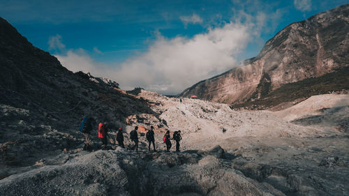 Panoramic view of people on mountain against sky