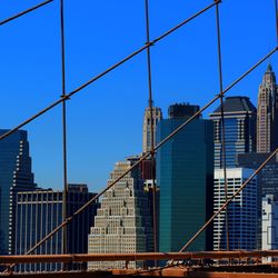 Low angle view of skyscraper against clear blue sky