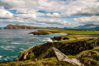 Scenic view of land and sea against sky