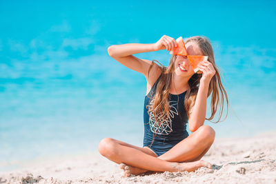 Young woman sitting on beach