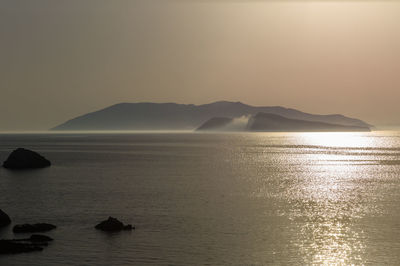 Scenic morning view of santorini from folegandros island  against clear sky