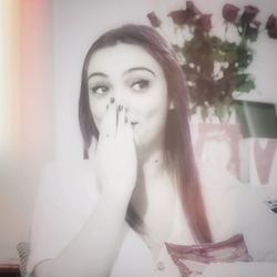 Portrait of young woman sitting at home