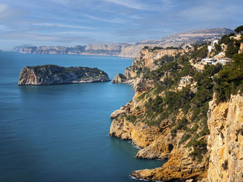 Scenic view of sea and rocks against sky