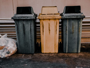 Garbage bin by wall