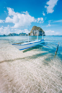 Scenic view of beach against cloudy sky