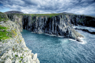 Scenic view of waterfall against sky