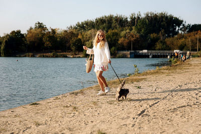 Man with dog standing in water