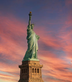 Low angle view of statue against sky during sunset