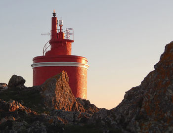 Low angle view of lighthouse against sky during sunset