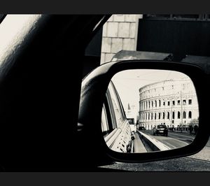 Reflection of buildings on side-view mirror