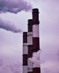 Low angle view of smoke emitting from chimney against sky