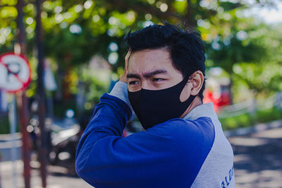 Portrait of young man standing outdoors