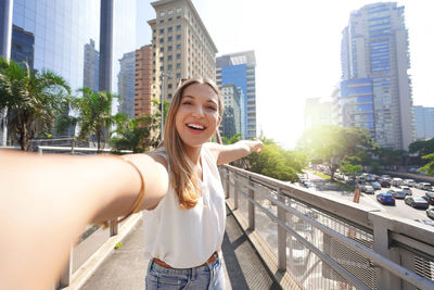 Travel in sao paulo, brazil. beautiful smiling girl takes self portrait in sao paulo, brazil.