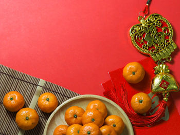 High angle view of fruits in container against orange background