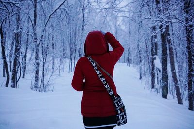 Woman in snow covered forest