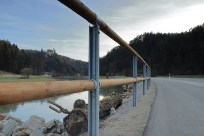 Road by river against sky