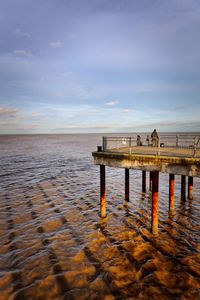 Pier over sea against sky