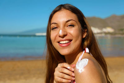 Portrait of a smiling young woman at beach