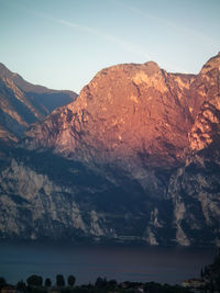 Scenic view of lake and mountains against sky during sunset