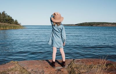 Man standing in lake against clear sky
