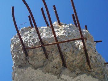 Low angle view of snow against clear blue sky