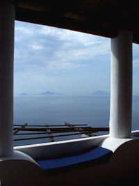 Sea against sky seen through balcony