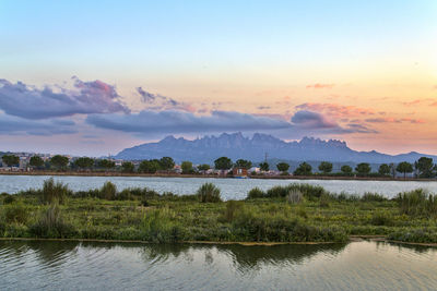 Scenic view of lake against sky during sunset