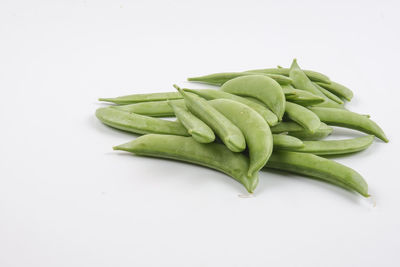 Close-up of green chili pepper against white background