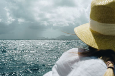 Midsection of man in sea against sky