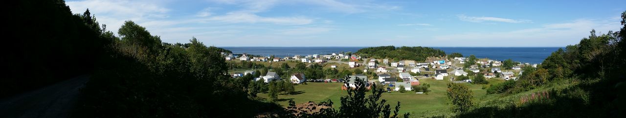 Panoramic view of sea and buildings against sky