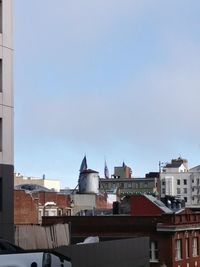 Buildings in city against clear sky