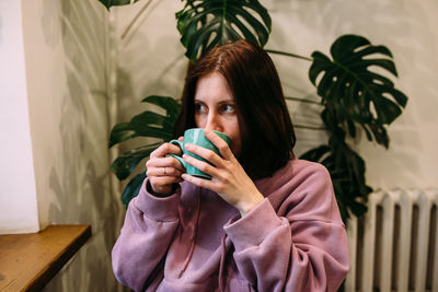 Young woman is drinking coffee in coffee shop. time for yourself.