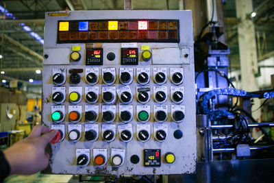 Cropped hand of man using sound mixer