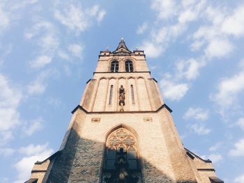 Low angle view of bell tower against sky