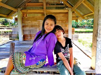 Portrait of smiling young woman sitting outdoors