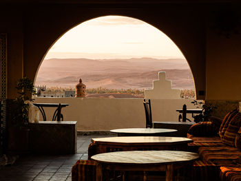 Beatutiful view through a half-round window in the dessert at sunrise