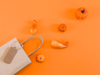 Craft package with scattered pumpkins on orange.