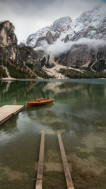 Scenic view of lake by snowcapped mountains