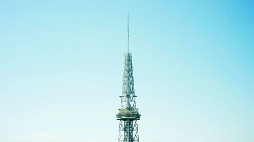 Low angle view of communications tower against sky