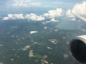 Aerial view of clouds over landscape seen from airplane