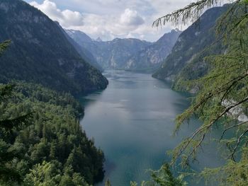 Scenic view of river amidst mountains against sky