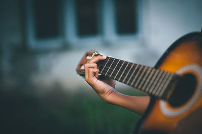 Close-up of person hand playing guitar