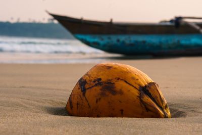 Close-up of boat moored on beach