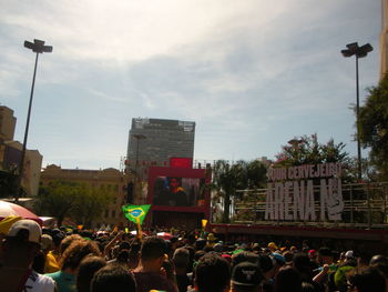 People on street in city against sky