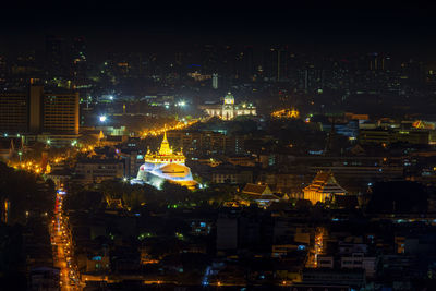 High angle view of illuminated buildings in city at night