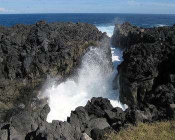 Scenic view of rocks on sea shore