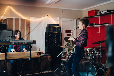 Performers playing instruments while practicing in studio