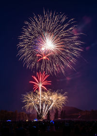 Low angle view of firework display at night