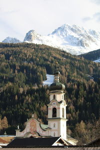 Built structure by mountains against sky