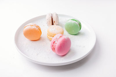 High angle view of candies in plate on table